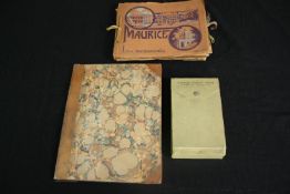 A couple of souvenir albums with black and white photos of places of interest along with a book of
