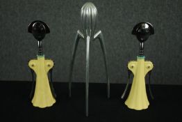 A pair of Alessi 'Anna G' corkscrews after a design by Alessandro Mendini and an Alessi 'Juicy