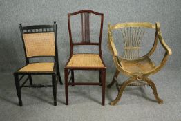 Three side chairs with caned seats, all circa 1900, including one with a painted x-frame, an