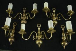 A set of three 17th century style brass twin branch wall lights, and a matching pair with single