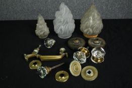 Three vintage frosted glass torch shades, glass door handles and associated brass parts. H.19cm. (