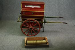 A mid-20th century, wind up music box, in the form of a miniature barrel organ with cart, 