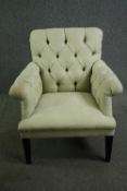 A contemporary armchair by Andrew Martin with green buttoned textured upholstery. H.90cm.