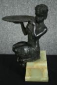 An early 20th century spelter or sand cast bronze figure of a faun on an onyx plinth base. H.37cm.