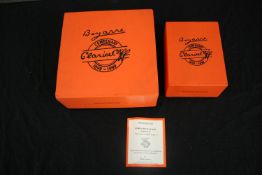 A Clarice Cliff Centenary collection 'Melon' pattern three piece tea set by Wedgwood, together