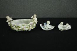 A Sitzendorf hand painted porcelain oval bowl with putti, circa 1900, and two similar smaller