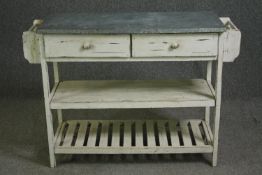 An early 20th century provincial white painted butchers block with a stone slab top. H.86 W.120 D.