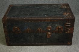 A vintage travelling trunk with lined floral decorated fitted interior. H.103 W.52 D.57cm. (Upright)