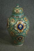 A North African hand decorated jar and cover, probably late 19th century. H.75cm.