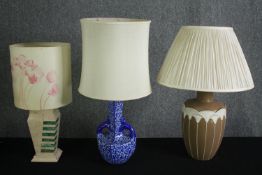 A miscellaneous collection of ceramic table lamps with their shades. H.60cm. (each).