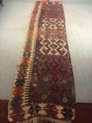 A section of a kelim cut for use as a hallway runner. L.335 W.94cm.