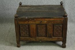 A lidded carved oak coffer, 18th century or earlier. H.57 W.77 D.59cm.