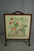 A mid century fire screen with tapestry insert, glazed. H.76 W.55cm.