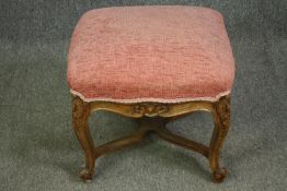 An early 20th century Louis XV style oak footstool with textured pink upholstery. H.44 W.50 D.50cm.