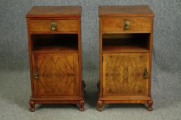 A pair of 1920s figured walnut bedside cabinets. H.76 W.39 D.36cm. (each).