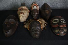 A collection of carved and painted African tribal masks. H.35 W.22cm. (largest).