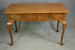 A Side Table by Waring & Gillow, rectangular top above four cabriole legs, two drawers to the front,