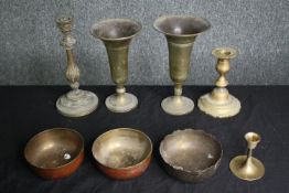A group of brass candlesticks, vases and bowls, 19th century and later. H.21cm. (largest).