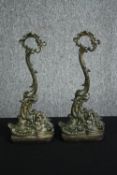 A pair of Louis XV style patinated bronze door stops. H.40cm. (each).