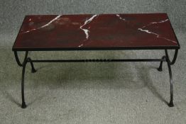 A coffee table with a rosso antico marble top on iron x-frame supports. H.43 W.93 D.47cm.