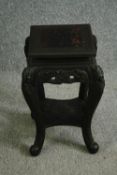 An early 20th century Chinese carved ebonised jardinière stand. H.56 W.36 D.36cm.