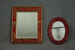 A red japanned and gilt decorated wall mirror, and a small oval lacquered mirror. H.56 W.45cm. (