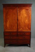 A late George III figured mahogany linen press, the interior cupboard converted with a hanging rail.