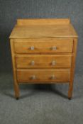 An early 20th century light oak Cotswold School style chest. H.86 W.68 D.44cm.