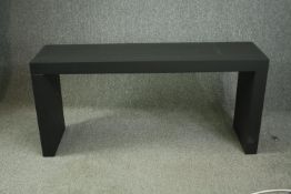A contemporary ebonised console table. H.70 W.150 D.40cm.