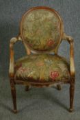 A George III beechwood armchair in the manner of John Linnell, with tapestry upholstery. H.95cm.