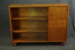 A mid 20th century satinbirch bookcase with sliding glass door. H.90 W.120 D.26cm.
