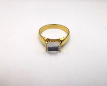 An 18 carat yellow gold and moonstone dress ring, set to centre with a claw set sugarloaf