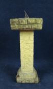 A weathered stone sundial on pedestal base. H.84 W.36 D.36cm.