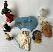 A collection of Art Deco and later wall masks etc. Largest W.38 D.31cm