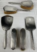 An Art Deco English hallmarked silver dressing set along with a similar hand mirror.