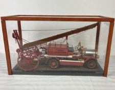 A model vintage fire engine in display case. H.28 W.48 D.19cm