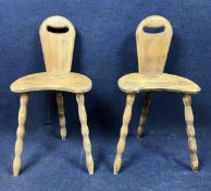 A pair of vintage tripod chalet chairs.