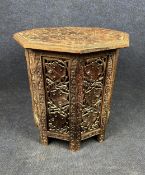 A profusely carved Eastern hardwood occasional table. H.48 D.48cm