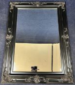 A contemporary wall mirror in Rococo scroll frame. H.115 W.86cm