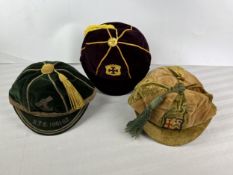 Three rugby football honours caps, velvet and braid with tassles and embroidered crests, early