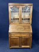 An early 20th century oak bureau bookcase with leaded glass doors. H.183.5 W.92.5 D.43.5cm