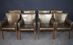 A set of eight armchairs upholstered in faux leather.