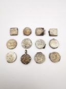 A collection of twelve Mughal Indian white metal rupee coins with raised calligraphic script,