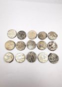 A collection of fifteen Mughal Indian white metal rupee coins with raised calligraphic script,