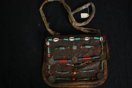 A vintage bead and shell decorated leather satchel. H.23 W.28cm.