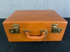 A vintage leather vanity case along with a similar smaller fitted case. H.15cm x W.35cm x D.25cm