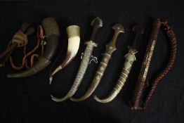 A collection of Eastern daggers and horns etc. L.40cm. (largest).