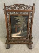A late 19th century carved hardwood Japanese screen with signed hand decorated panel to each side.