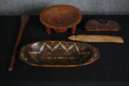 A collection of carved tribal bowls and other implements. L.44 W.18cm. (largest).