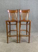 A pair of laminated beech and bentwood counter stools. H. 108 cm x W. 40 cm x D. 43 cm
